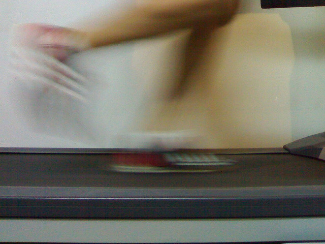 blurred feet running on treadmill